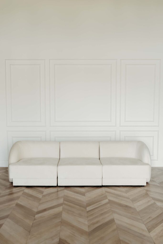 Studio fotograficzne wynajem – scenka z elegancką kanapą na tle białej ściany ze sztukaterią, Warszawa